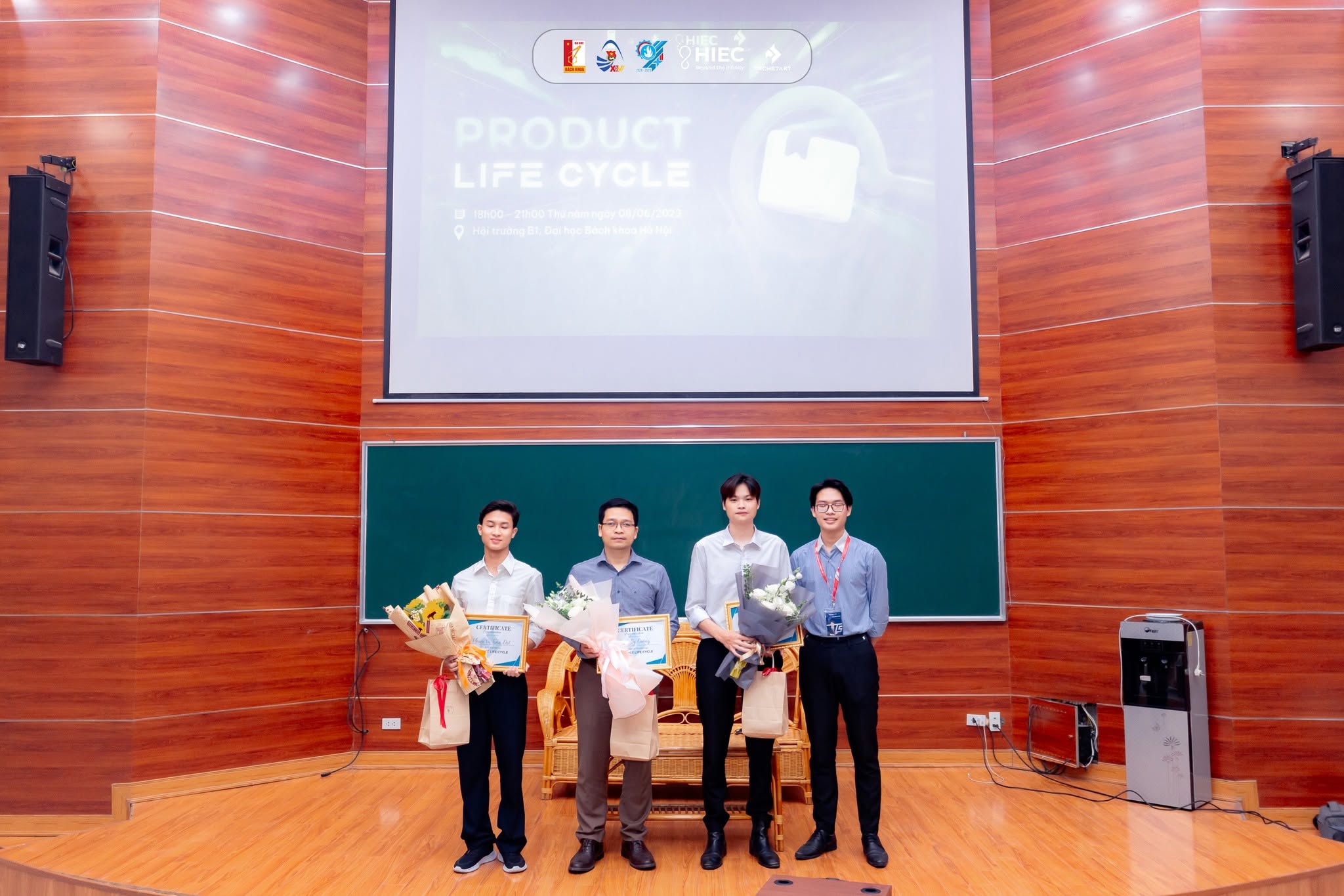 Certificates and flowers presented to the host and speakers